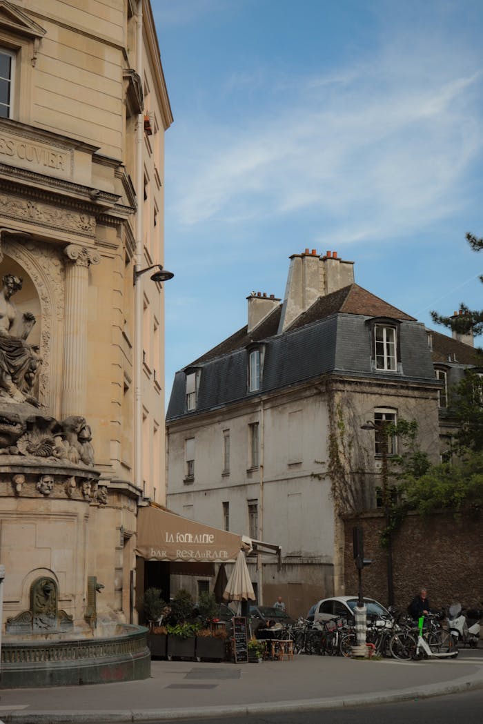 Historic Parisian street view featuring charming architecture, classic buildings, and a quaint cafe.